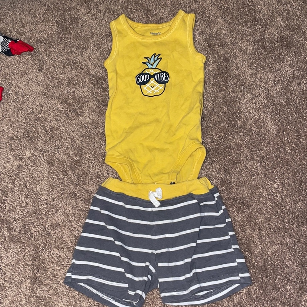 Yellow cut off pineapple shirt, and shorts.